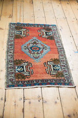 Distressed fringe and floral border of a vintage Oushak rug with brick red field.