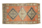 Distressed vintage Oushak rug with triple medallions in pale burnt orange, charcoal, and mint green, 1'10
