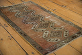 Distressed vintage Oushak rug texture, featuring copper, ivory, and coffee brown geometric motifs.