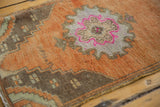 Distressed pile texture of a vintage Oushak rug with fuchsia and coffee brown accents.