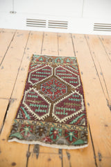 Vintage distressed Oushak rug's geometric aubergine, mint, bronze pattern with foundation wear.