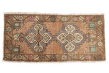 Distressed vintage Oushak rug mat with double serrated medallions in coffee, slate, and rose.
