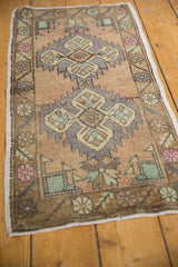 Distressed vintage Oushak rug with serrated medallion and quatrefoil floral design.