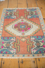 Vintage Oushak rug ivory medallion, brick red field, fuchsia plant motif, even wear texture.