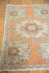 Faded wine red medallion, tangerine and ivory germinating plant motifs on distressed Oushak.