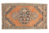Distressed vintage Oushak rug, terracotta with charcoal medallion and tree-of-life pattern.