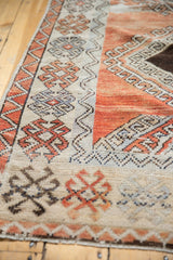 Distressed vintage Oushak rug detail with crab style border, zig-zag vine, and hook motifs.
