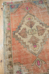 Distressed vintage Oushak rug texture, pale terracotta, bronze, pink accents, and visible wear.