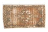 Distressed vintage Oushak rug with stepped medallion, bronze, copper, and grey-blue tones.