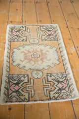 Distressed Oushak rug pile detail with germinating plant motif and visible foundation wear.