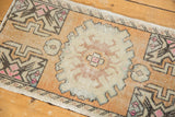 Distressed vintage Oushak rug texture with even wear and faded burnt orange plant motifs.