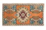 Distressed vintage Oushak rug mat with terra cotta, ivory medallion, and colorful geometric motifs.