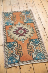 Oversized center medallion with burgundy germinating plant motif on distressed Oushak rug.