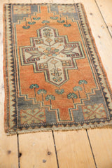 Geometric contours and mint green flowers on a distressed vintage Oushak rug.