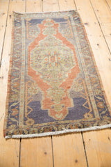 Distressed Oushak rug corner detail, royal blue, terra cotta medallion, and even wear.