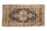 Distressed Oushak runner with ornate floral medallion, dark charcoal, mauve, and ivory, 2'x3'9