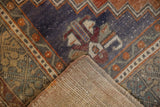Distressed royal blue and terra cotta Oushak rug pile with visible hand-knotted foundation.
