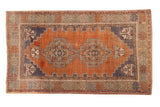 Distressed vintage Oushak rug with double geometric medallion, terra cotta and royal blue hues, 3'10