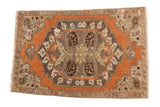 Distressed Vintage Oushak mat with oversized floral medallion in rust, grey, and ivory. 1'9
