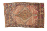 Distressed Oushak rug mat with geometric medallion, peach, ivory, aubergine, and even wear.