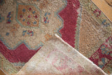 Distressed Oushak rug's cherry red and beige pile texture revealing its hand-knotted foundation.