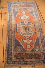 Distressed Oushak rug's roundel medallion, germinating spandrels, pale rust and blue.