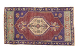 Distressed aubergine Oushak rug runner with antique ivory medallion and soft patina.