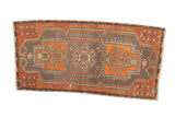 Distressed Oushak runner with triple floral medallions in rust, dark grey, and mint.