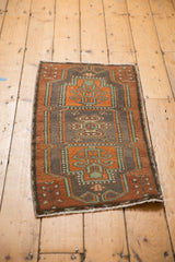 Distressed vintage Turkish Oushak runner showing geometric medallions in rust, sea foam green, charcoal.