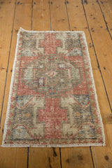 Distressed pile texture of a vintage Oushak rug in dusty rose, grey, and ivory.