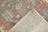 Distressed pile texture of a vintage Oushak rug revealing its hand-knotted reverse.