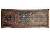 Distressed vintage Oushak runner featuring blush, denim blue, and brown geometric medallions, 3'3