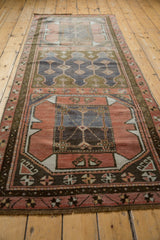 Distressed Oushak runner, primitive geometric medallion with blush and denim blue abrash.