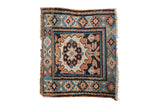 Antique Kurdish bag face with an oversized central palmette in rust, navy blue, and charcoal brown.