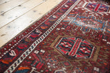 Vintage Karaja runner detail: geometric medallion, cherry red, sky blue, and foundation wear.