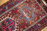 Karaja runner's geometric hook and latch motifs, cherry red, sky blue, and foundation wear.