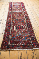 White fringe and cherry red, sky blue geometric patterns on a vintage Karaja runner.