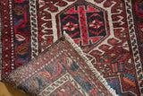 Vintage Karaja runner's hand-knotted reverse, revealing fringe and a cherry red geometric pattern.