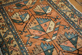 Vintage Heriz rug with oversized geometric patterns in madder red, green, blush, showing mostly even wear.