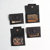 Four leather and rug fragment mini wallets featuring unique textile patterns.
