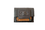Dark leather and orange woven rug fragment coin purse with an embossed logo flap.