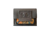 Handmade leather coin purse with a unique hand-woven rug fragment in orange and teal.