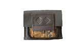 Handmade dark brown leather coin purse with a vintage rug fragment in a gold and blue geometric pattern.
