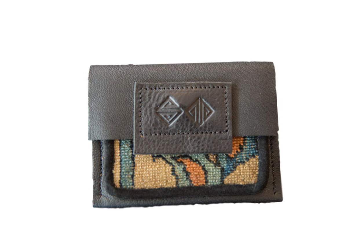 Leather and Rug Fragment Wallet with an embossed logo, teal, orange, and beige pattern.