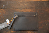 Black leather coin purse wallet back with metal zipper and mini tassel.