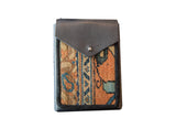 Shoulder bag detail: textured rug fragment with orange, blue, and tan pattern, gray leather flap.