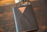 Pebbled dark leather back flap with peach detail and Swag and Tassel embossing.