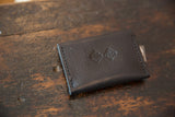 Dark brown textured leather Dainty Wallet with embossed logo and precise stitching.
