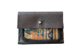 Dainty Rug Fragment Wallet with dark pebbled leather and colorful patterned textile.
