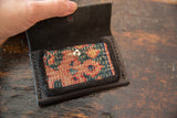 Dainty Rug Fragment Wallet interior, with a colorful hand-woven pattern and snap.